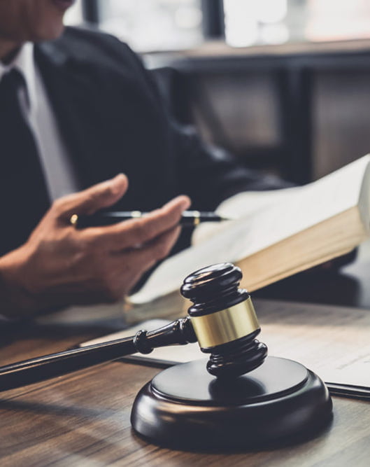 Lawyer discussing legal strategy with a gavel and legal documents on the desk.