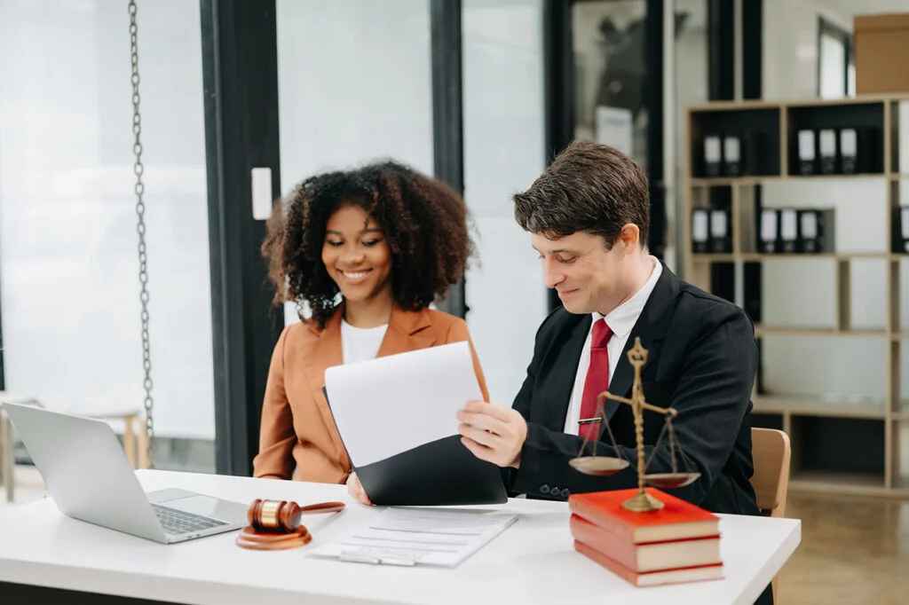 Lawyer and client discussing professional negligence claims documents