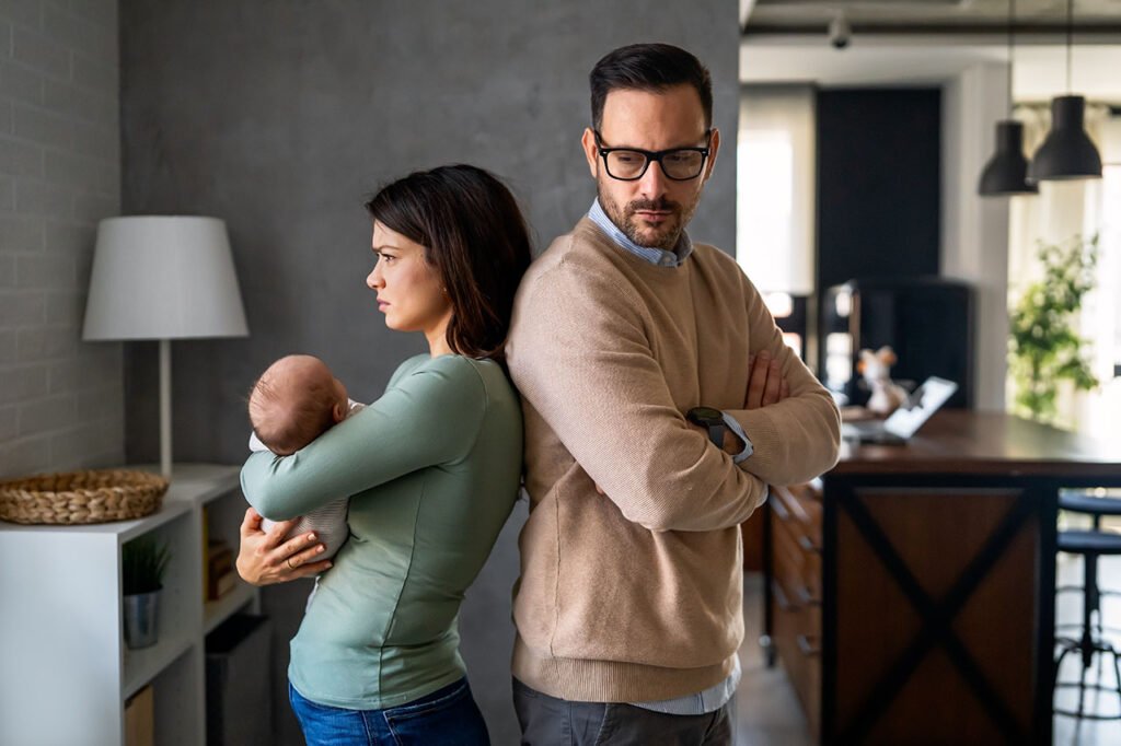 Stressed couple with a baby facing relationship challenges