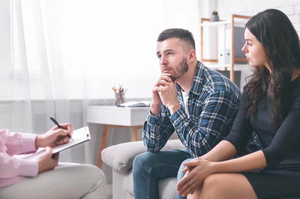 Couple in a serious discussion with a family law Dandenong Solicitors.