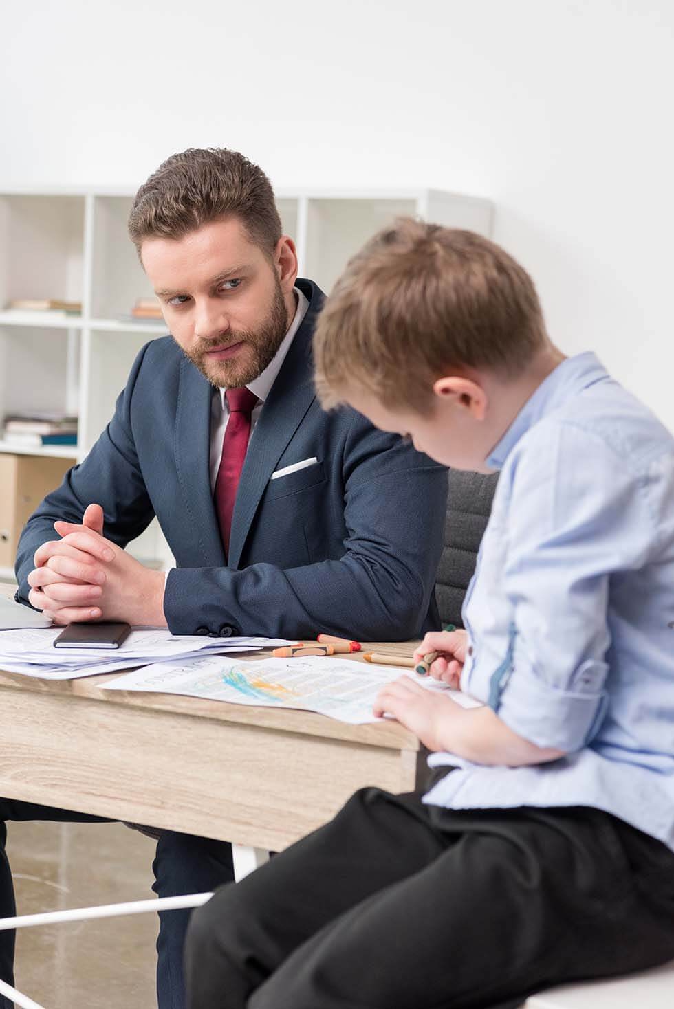 Family lawyer discussing child support with a parent and child.