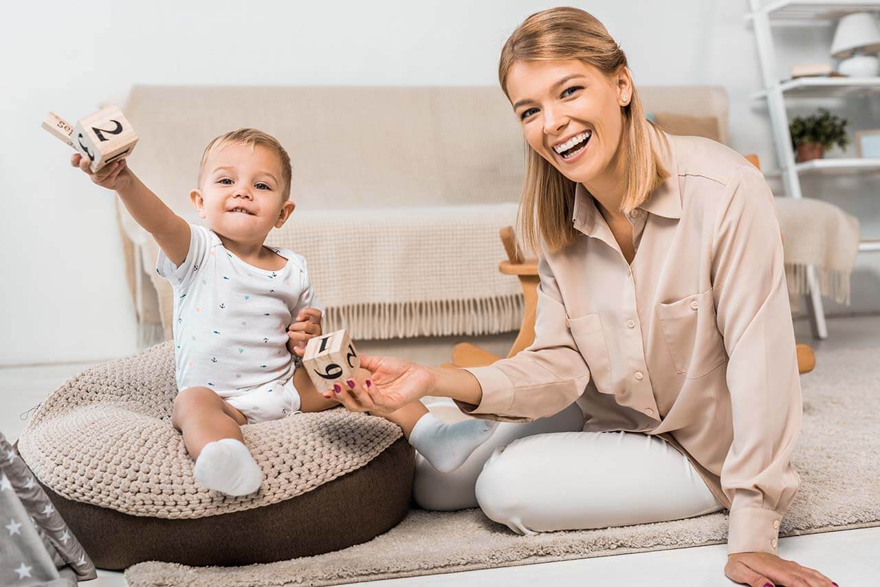 Mother playing with her child, symbolising care arrangements in family law.